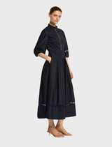 Chic Olivia dress in ink color, highlighting a flattering shape and elegant design, suitable for special gatherings.
