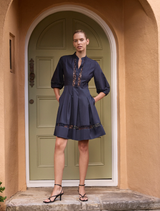 Navy Olivia short dress featuring a fitted bodice and flared skirt, perfect for casual or semi-formal occasions.