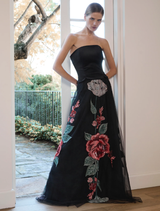Black rose-patterned Olympia skirt displayed on a hanger against a neutral background.