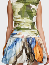 A model wears a skirt featuring a lively floral print, adding a touch of nature-inspired elegance to her outfit.