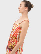 A bright orange Tylis top hanging, highlighting its modern cut and fabric texture.