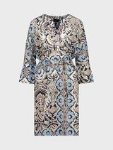 Elegant women's beach tunic dress showcasing intricate blue and white paisley patterns against a black fabric.