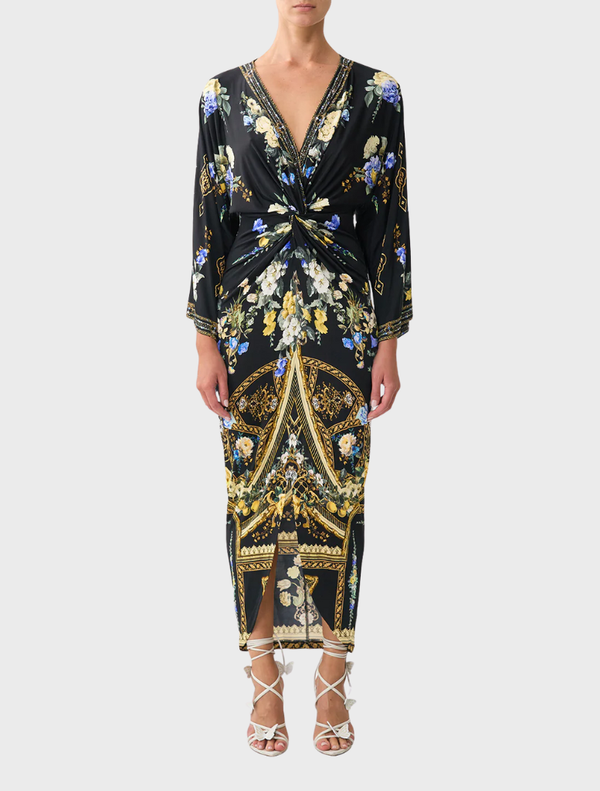 Elegant long dress with a split front and twist design, showcasing Ottoman-inspired style and refined draping.