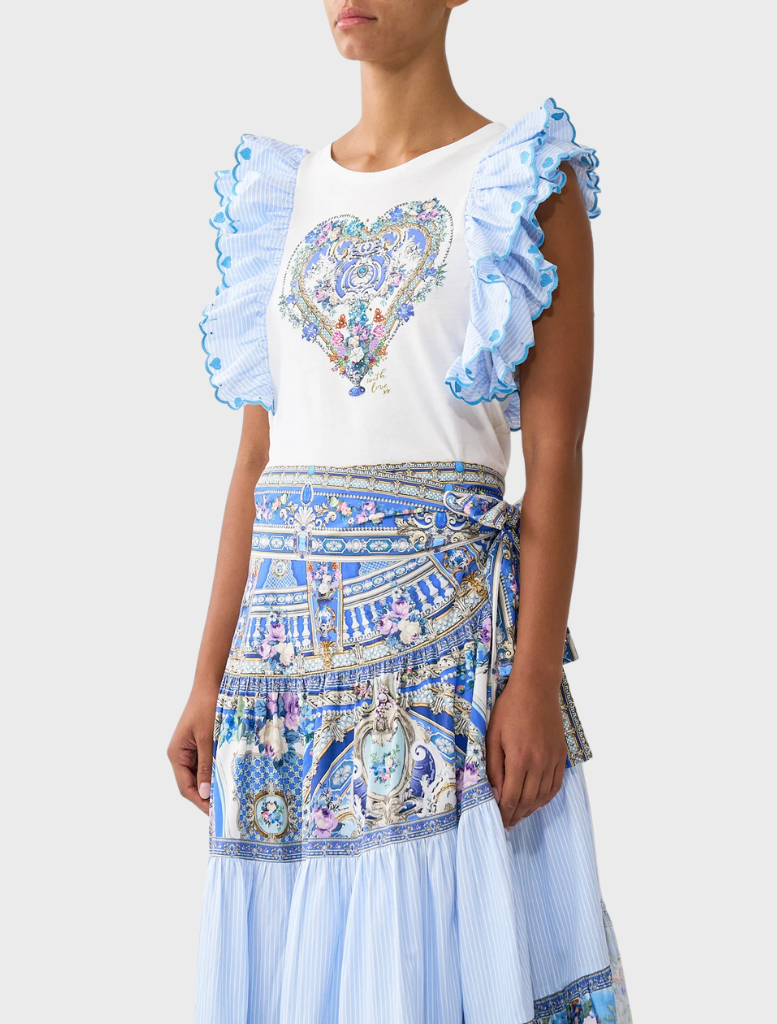 A blue and white skirt featuring a patterned fabric, styled with a Double Frill Sleeve Tee from Ottoopp.