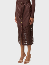 Stylish oxblood leather midi skirt featuring custom laser cuts, perfect for adding flair to any outfit.