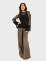 A black Pacos top hanging, highlighting its minimalist style and elegant silhouette.