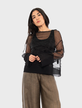 Black Pacos top displayed on a hanger, showcasing its sleek design and fabric texture.