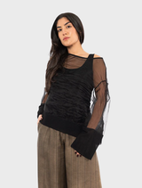 A black Pacos top hanging, highlighting its minimalist style and elegant silhouette.