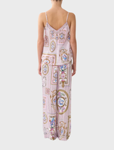 Back view of a woman in a pink and white printed dress, showcasing the Button Front Lounge Pant Palapast design.