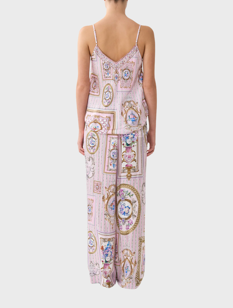 Back view of a woman in a pink and white printed dress, showcasing the Button Front Lounge Pant Palapast design.