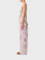 A model showcases a pink and white floral print jumpsuit labeled as Button Front Lounge Pant  Palapast.