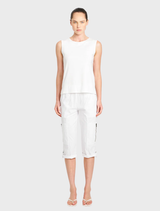A model displays a chic look in a white tank top paired with white Palazzo Shell pants.