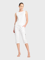 Model wearing a white tank top and white Palazzo Shell pants, showcasing a stylish and minimalist outfit.