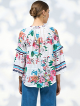 White floral dress with long sleeves and a ruffled skirt, referred to as Pandora Blouse - White Multi.