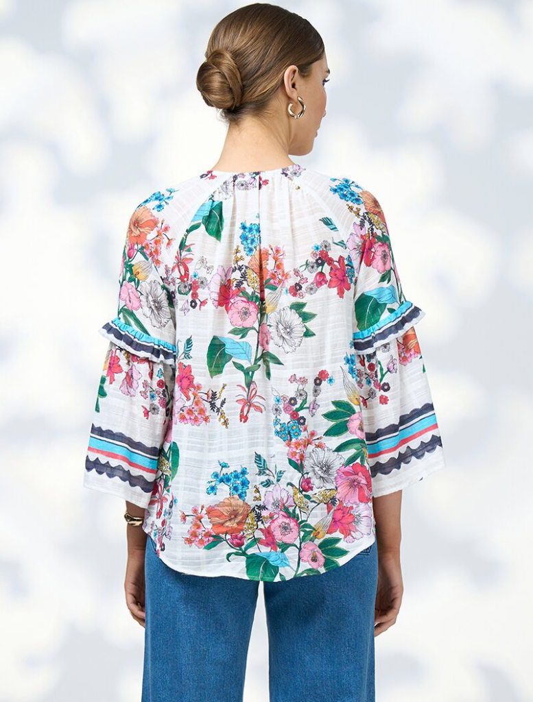 White floral dress with long sleeves and a ruffled skirt, referred to as Pandora Blouse - White Multi.