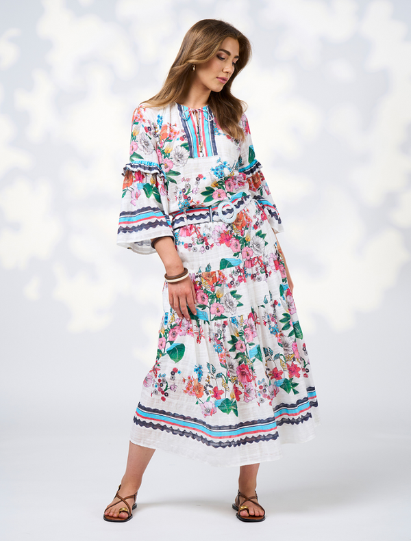 Long-sleeve white floral dress with a ruffled hem, featuring a flowing skirt, labeled as Pandora Blouse - White Multi.