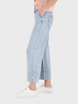 ⅞ length wide-leg jeans in light denim, 100% lyocell, featuring side pockets and a wide hem, modeled by a tall individual.