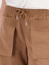 Mocca shorts designed with an elastic waistband, patch pockets, and cuffs, versatile for any occasion.