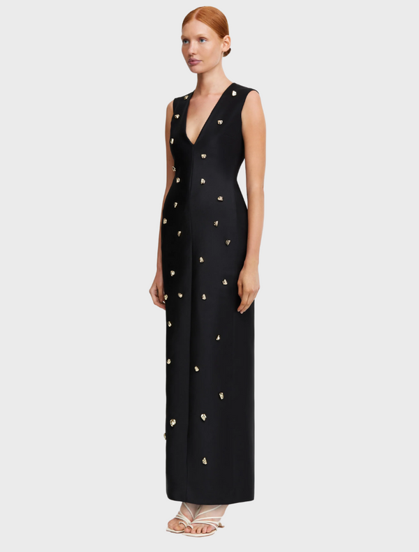 Elegant black evening gown featuring a pattern of gold stars, perfect for a glamorous night out.