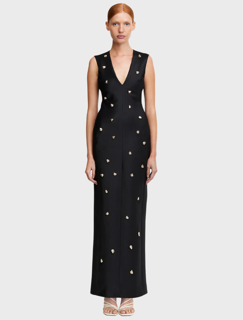  A black evening gown adorned with gold stars, creating a striking and elegant design for formal occasions.