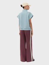 The Paulamd SS T-neck in Arona displayed on a hanger, highlighting its stylish neckline and color.