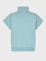 The Paulamd SS T-neck in Arona laid flat, emphasizing its unique color and fabric pattern.