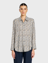 A close-up of a soft shirt adorned with a stylish pendant, highlighting its chic and comfortable appeal.