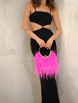 A vibrant pink feather purse with a decorative metal ring, showcasing a trendy and playful design.