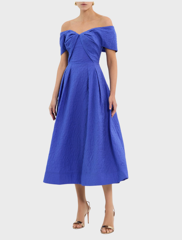 A stylish blue dress with a ruffled neckline, showcasing a chic and feminine design.