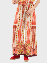 Orange Persol pants folded neatly, featuring a smooth finish and modern cut.