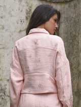 Stylish pink Tweedle Bow Jacket showcasing a prominent bow, ideal for a trendy and fun fashion statement.