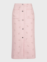 Chic pink tweed skirt designed with a sophisticated look, ideal for enhancing any wardrobe with a touch of elegance.