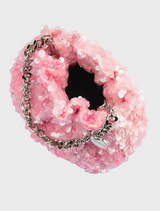 Stylish pink purse with sequins and a chain strap, the Mattie Sequin Pouch adds flair to any ensemble.