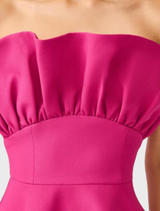 Strapless structured gown in pink orchid, featuring an asymmetric cut that adds a contemporary flair to formal wear.