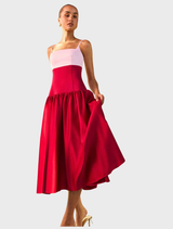 The June gown showcases a white bodice with a flowing red and pink skirt.