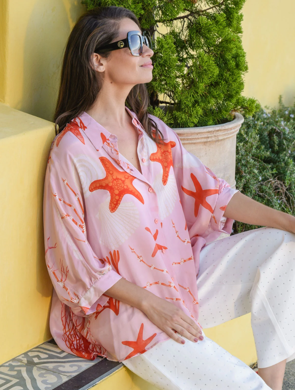 Stylish pink shell shirt showcasing a distinctive open back design, ideal for casual or semi-formal occasions.