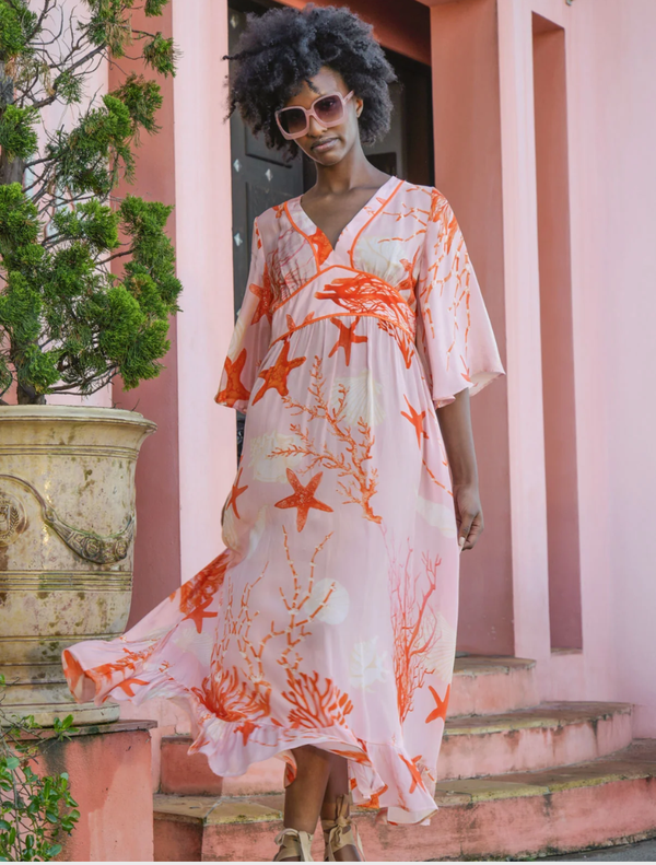 A pink shell dress showcasing a striking fire pattern, designed to make a statement at any event or occasion.