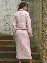 Stylish pink tweed skirt with a textured finish, offering a versatile option for both day and evening wear.