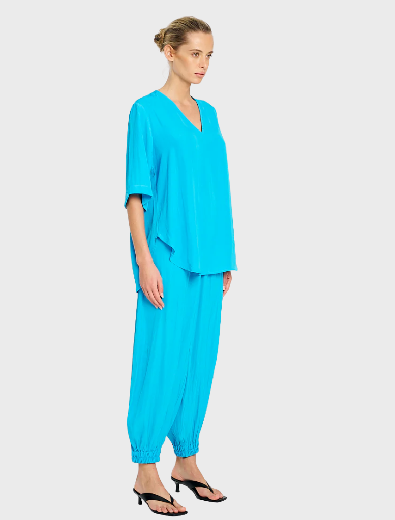 Swish Plaza Top in a vibrant cerulean hue, designed for comfort and elegance, suitable for various settings.