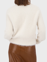 Almond-colored plush cardigan jacket with a soft texture, designed for warmth and style during cooler seasons.
