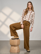 Bronze Polaris Pant displayed on a white background, showcasing its sleek design and fabric texture.