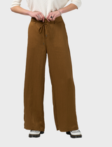 Bronze Polaris Pant hanging on a hanger, illustrating its elegant design and high-quality material.