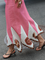 A flowing midi skirt in a vibrant poppy antique color, featuring a stylish design suitable for various occasions.