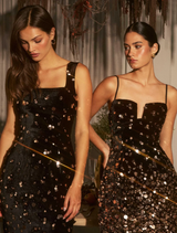 Black and gold embellished gown featuring a square neckline, adjustable straps, and a fitted floor-length silhouette.