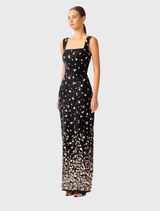 Primelle gown in black and gold showcases a sleek design with a square neckline, adjustable straps, and floor-length fit.