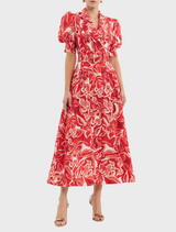 A red dress adorned with a delicate floral pattern in white and red hues.