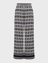 Fashionable midnight blue pants with a unique multi-colored print, suitable for both casual and dressy events.