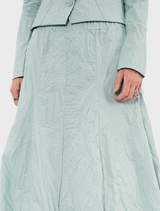 Elegant mint poplin skirt featuring a colorful print, designed for comfort and style in warm weather.
