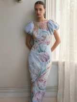Elegant blue floral midi dress with puff sleeves, designed for a feminine silhouette and perfect for warm weather events.