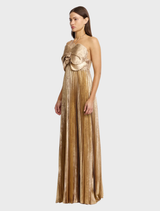 Elegant gold Pullford maxi dress hanging on a rack, showcasing its long, flowing design and luxurious fabric.